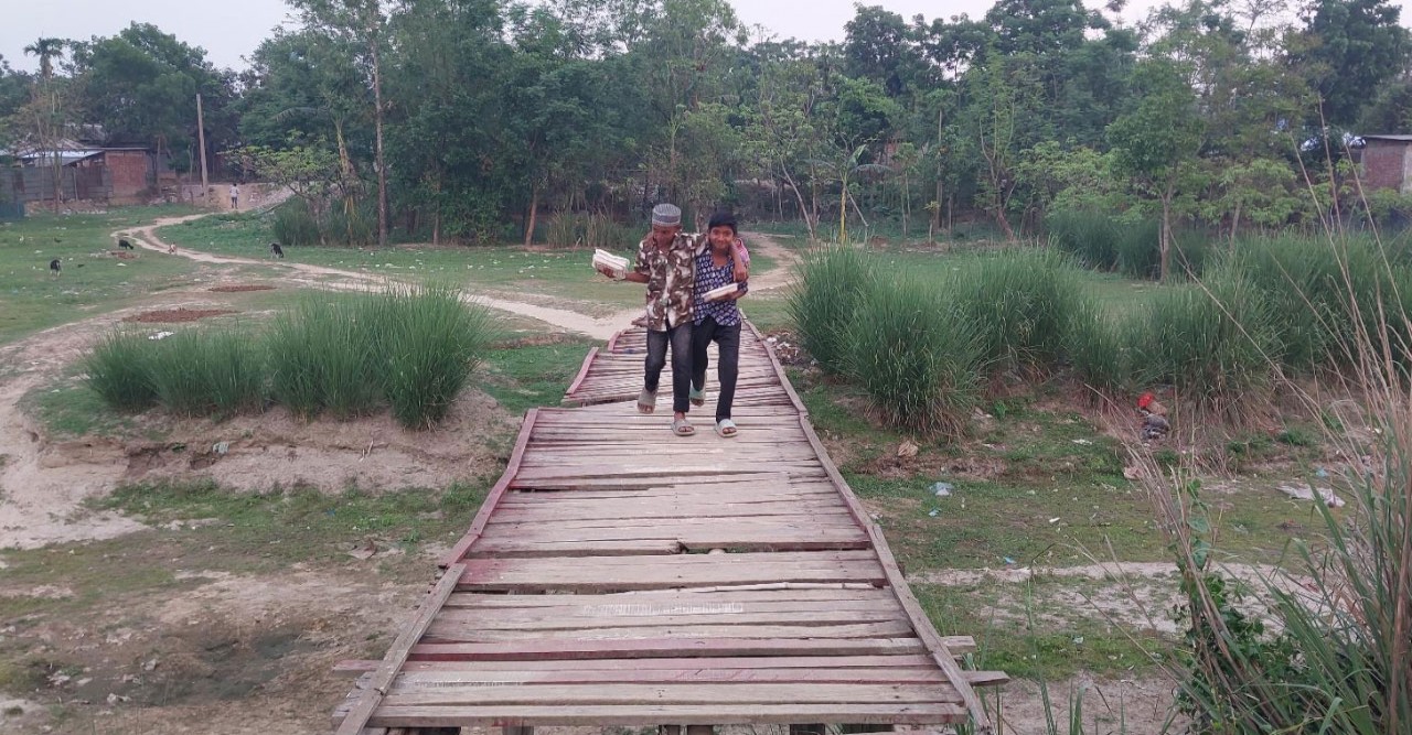 নড়বড়ে কাঠের ব্রিজ দিয়ে ঝুঁকি নিয়ে স্কুলে যায় শিশুরা